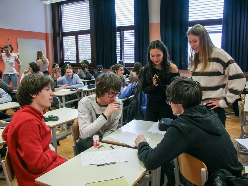 A secondary-school class in discussion: students talk a question through across their desks